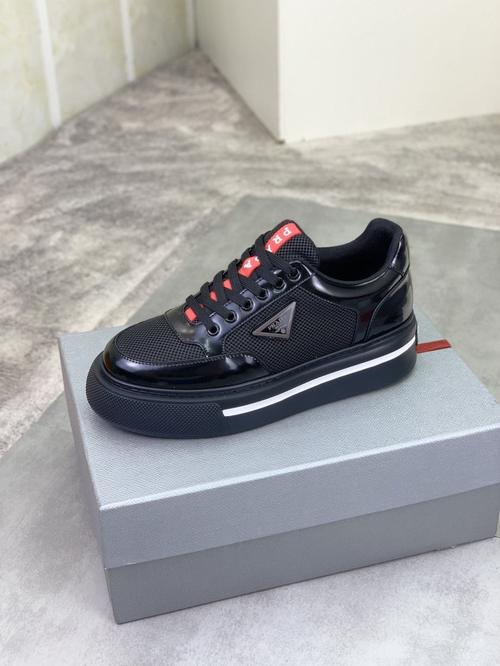 Prada Triangle Patch Low-Top Sneakers — hero
